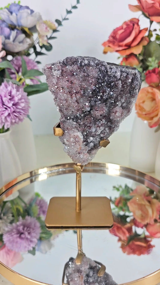 Quartz with pink and Black inclusions on Stand